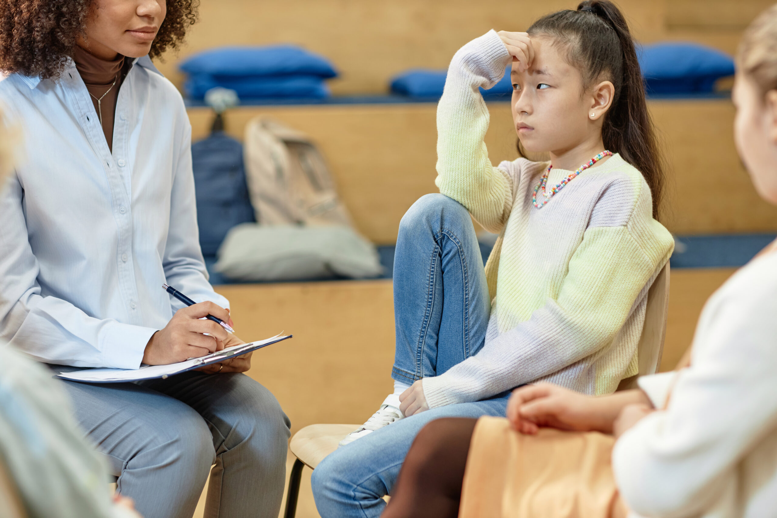 Asian Teenage Girl Listening To Female Psychologist during a Care Region Inc Psychiatric Rehabilitation for Child and Adolescents session